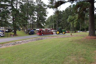 A John Deere tractor pulls a wagon load of Family & Farm Day guests.