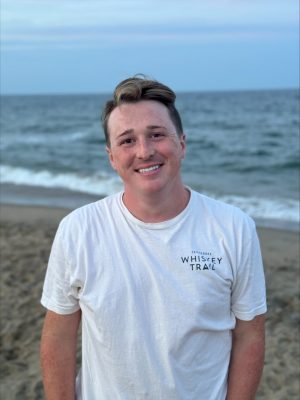 Young man standing on beach with ocean in background