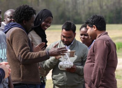 A group of students in field using drone technology 