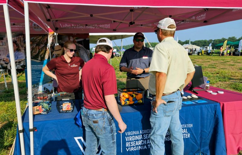 Attendees visit VSAREC booth.